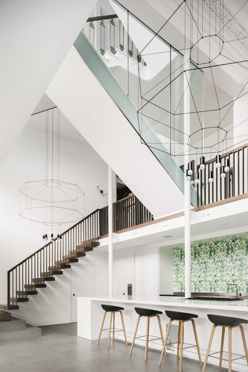 Double height kitchen space with decorative pendants