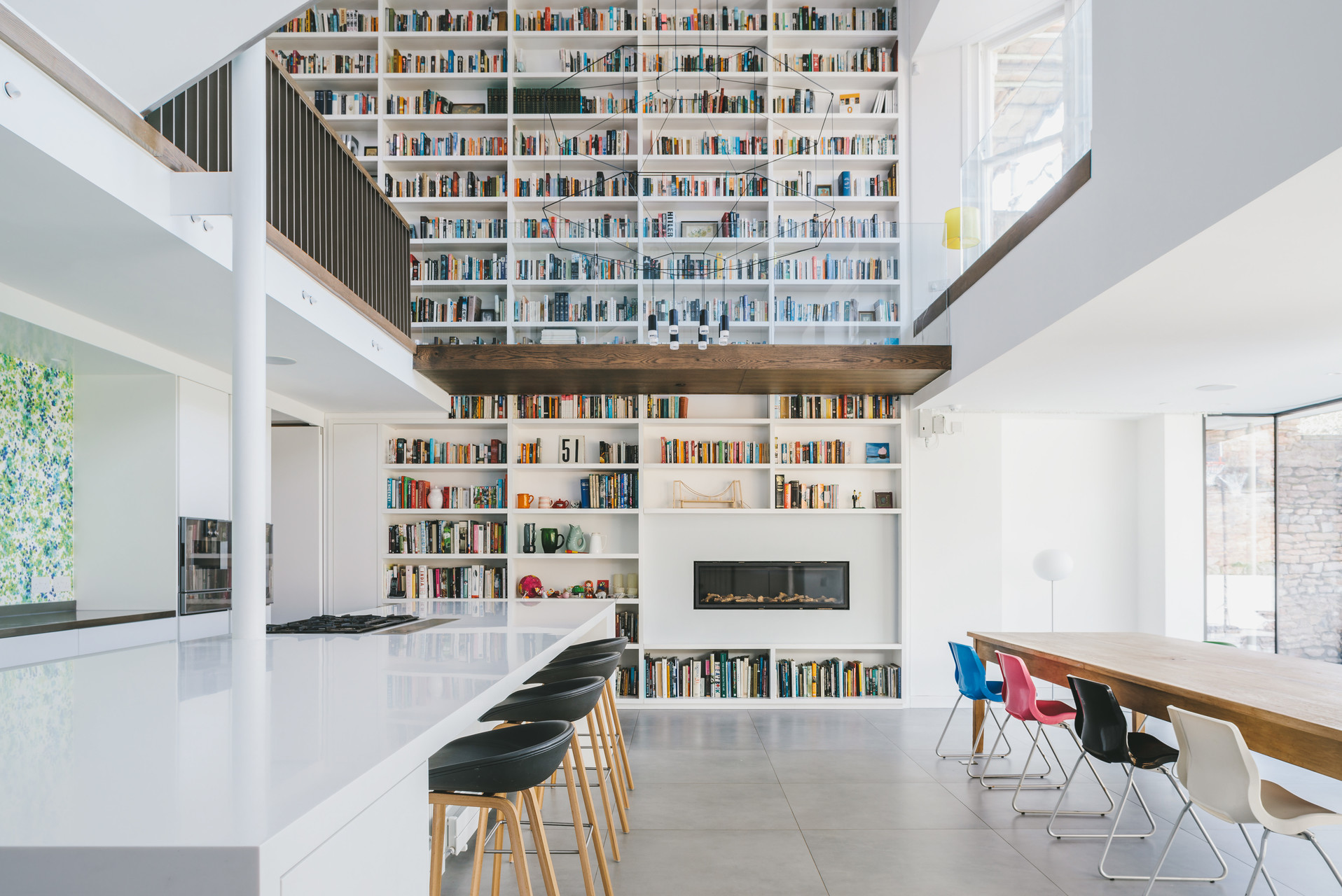 Double height kitchen with bookcase design