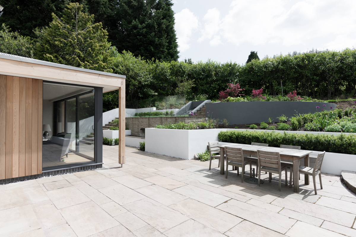 Modern timber glazed extension and terraced garden