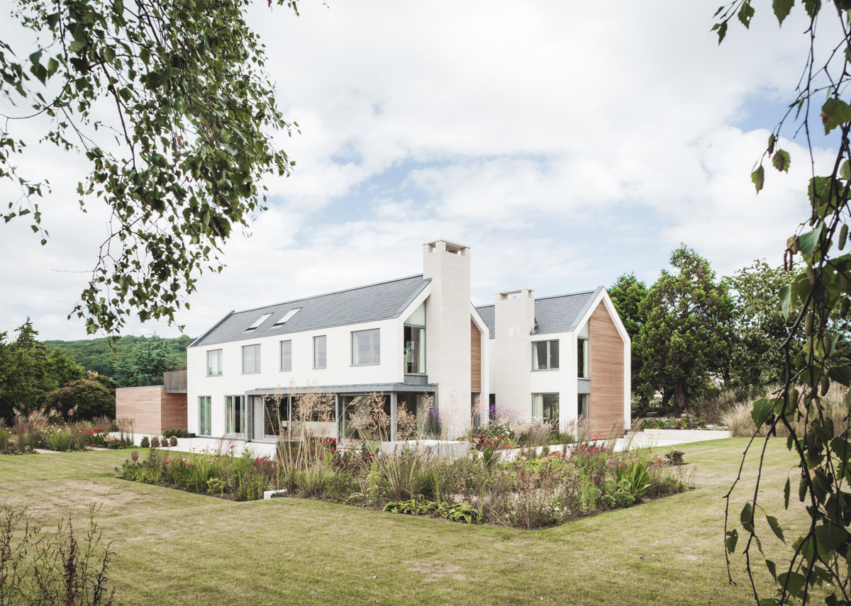 Modern double pitched new build with chimneys