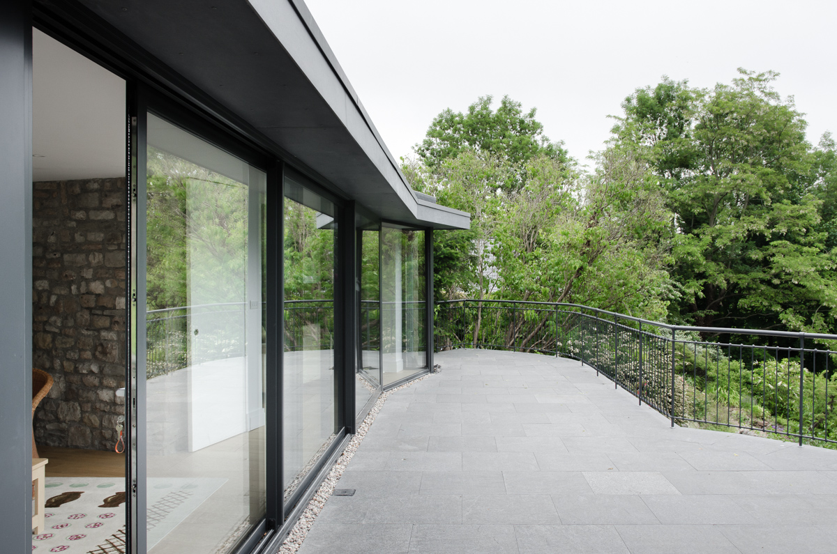 Glazed wall modernist extension to bristol house with terrace