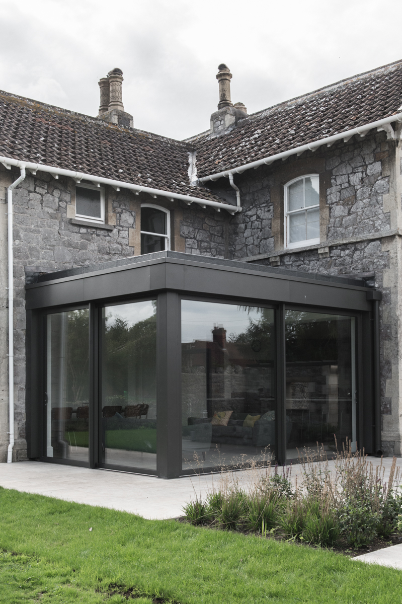 Glazed corner extension with sliding doors