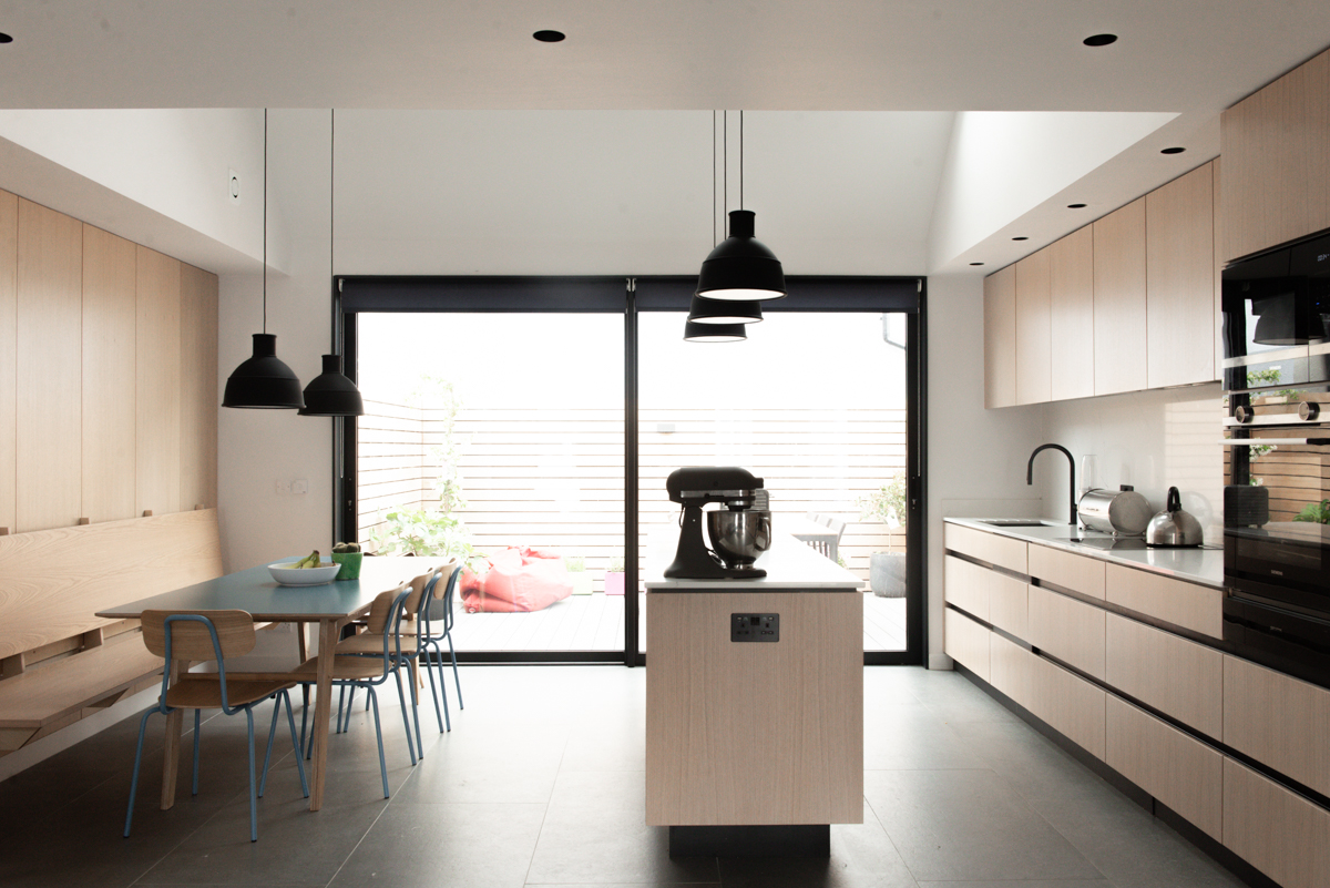Bespoke kitchen with island and sliding doors in modern new build bristol