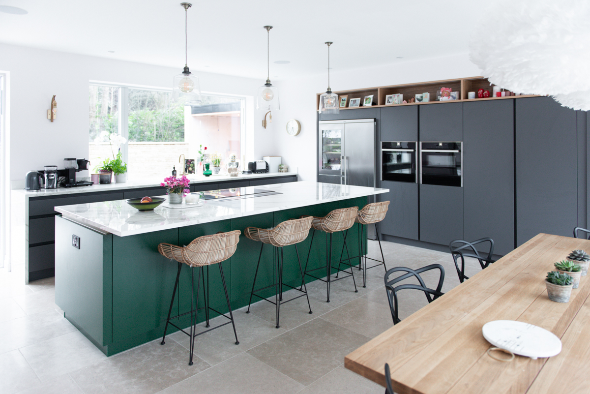 Large green kitchen island with four stools