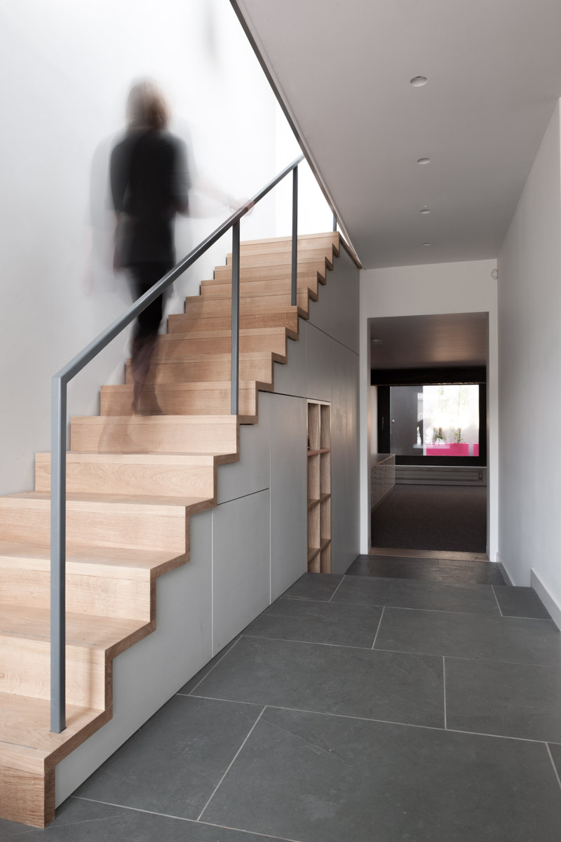 Timber lined staircase with built in storage beneath