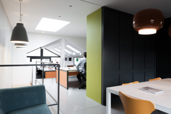 Bright office interior with orange desks & chairs