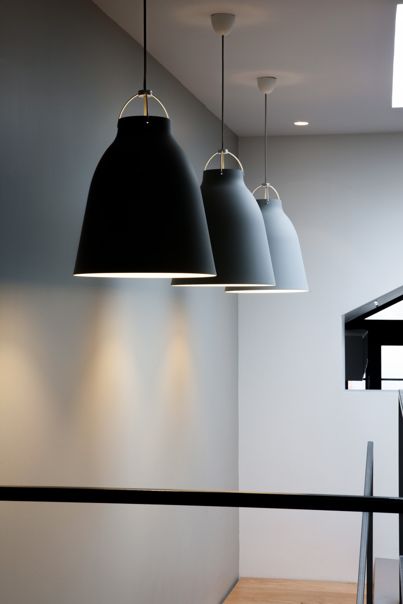 Three large pendant lights over stairwell
