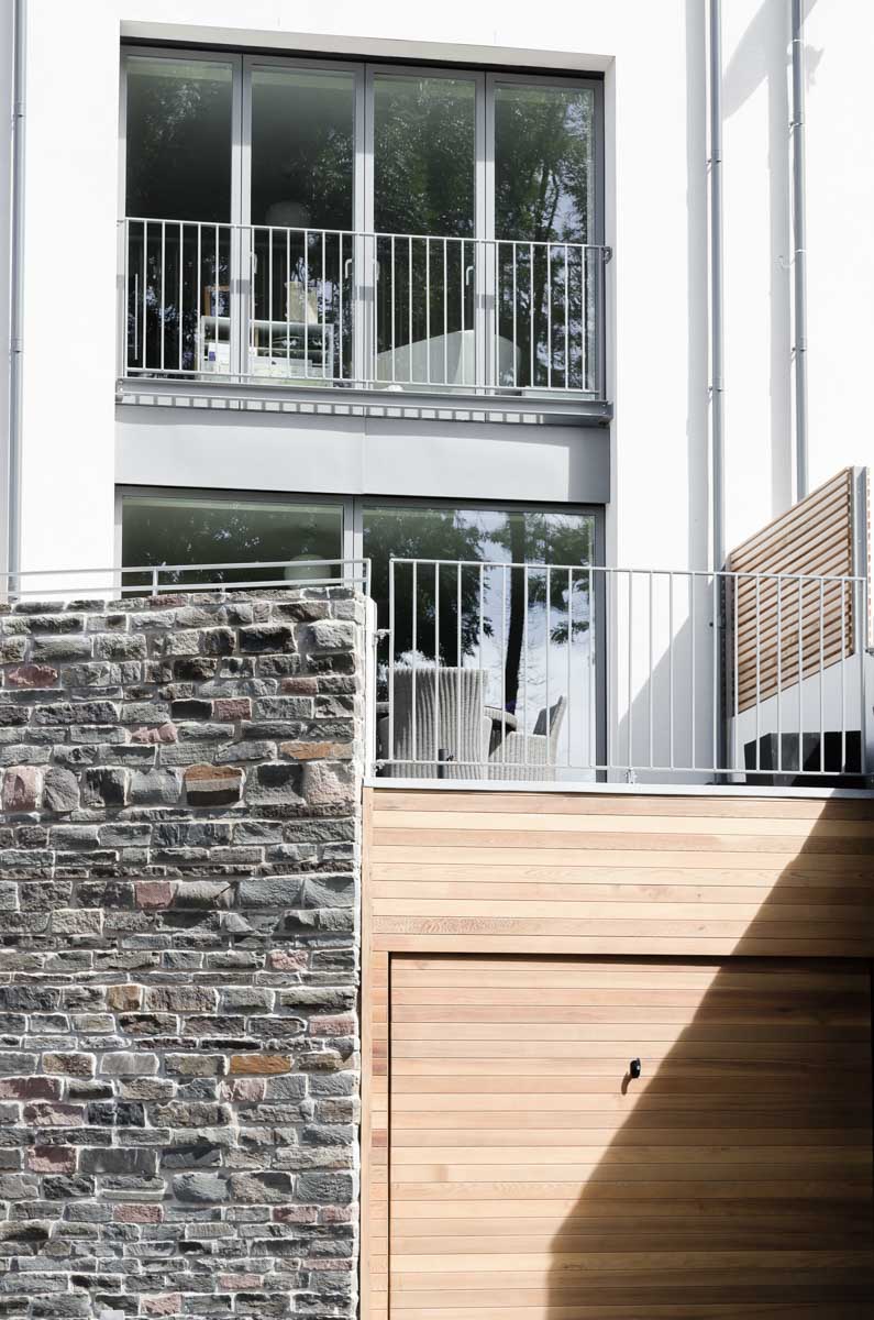 Timber garage door in rubble stone wall